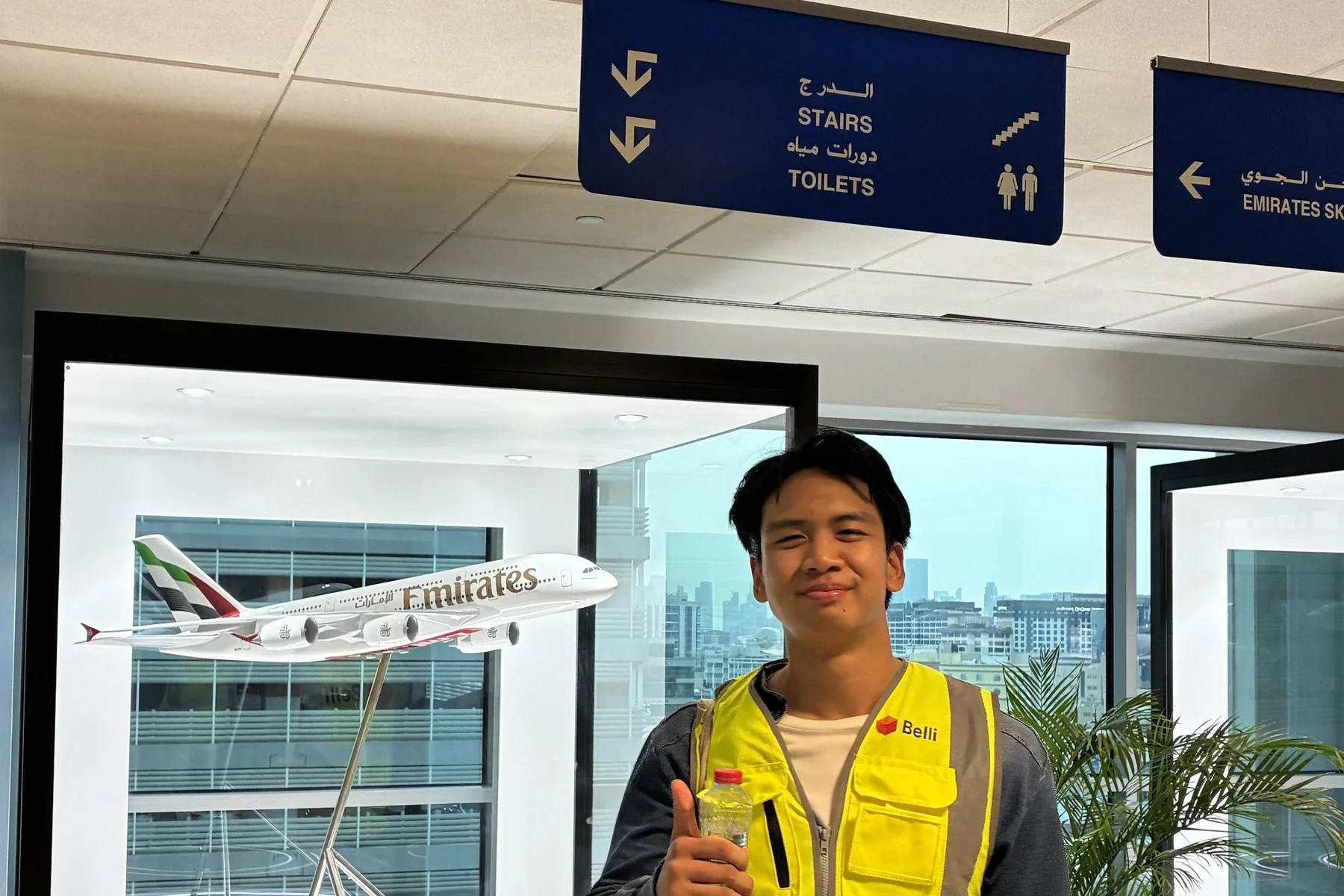 A Belli team member beside the Emirates A380 model display